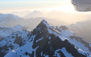 Snow capped mountain views from an airplane on the Tofino Air Sand to Summit Tour